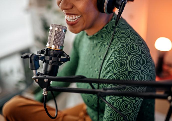 woman wearing a headset speaking into a microphone